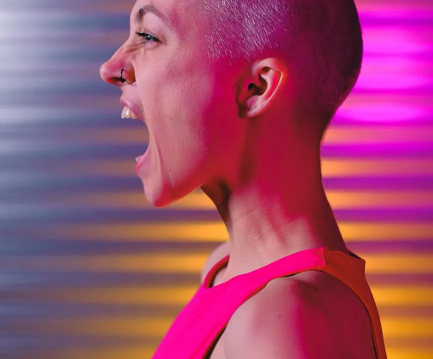 expressive bald woman shouting in studio